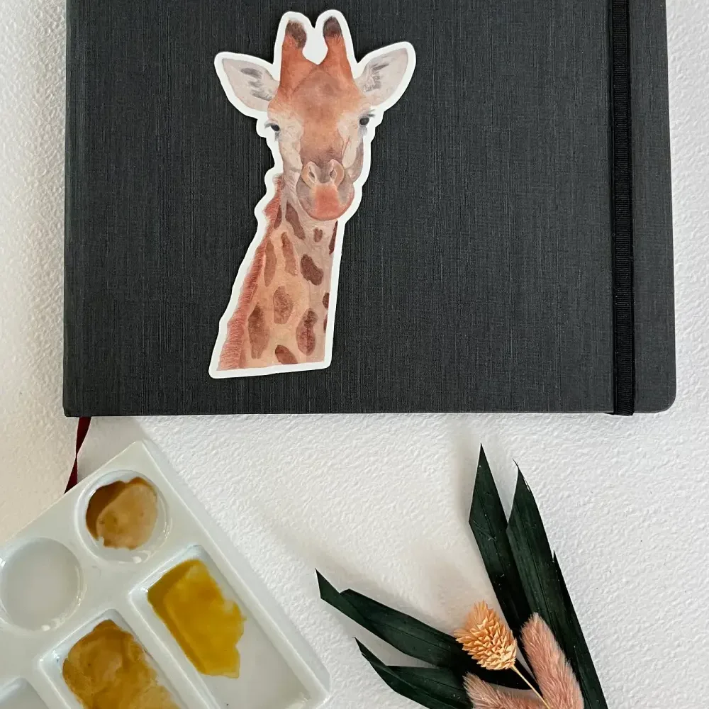 watercolor giraffe vinyl sticker on notebook