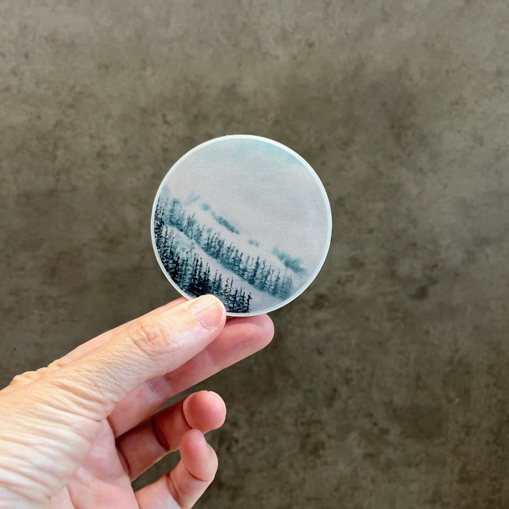 Landscape Mountain forest vinyl sticker held in hand