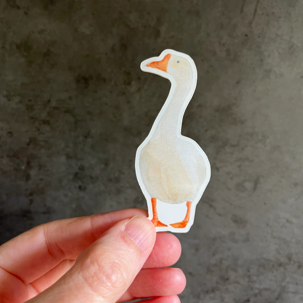 Goose vinyl sticker held in hand